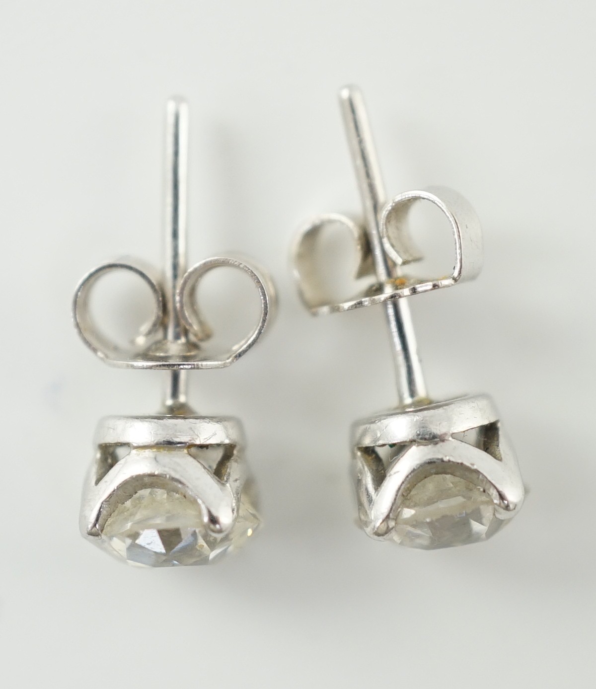 A pair of white gold? and solitaire diamond set ear studs